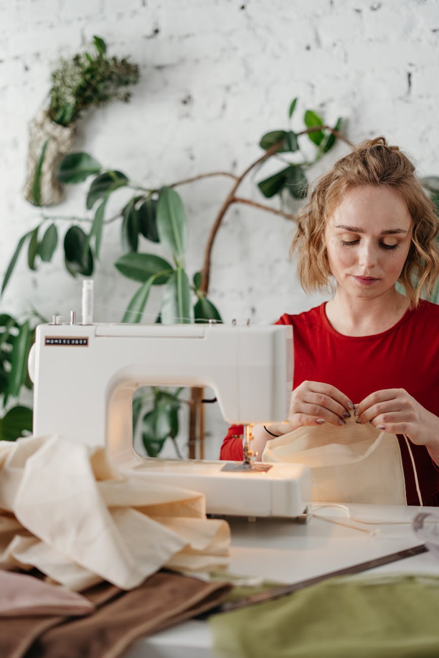 woman sewing a fabric